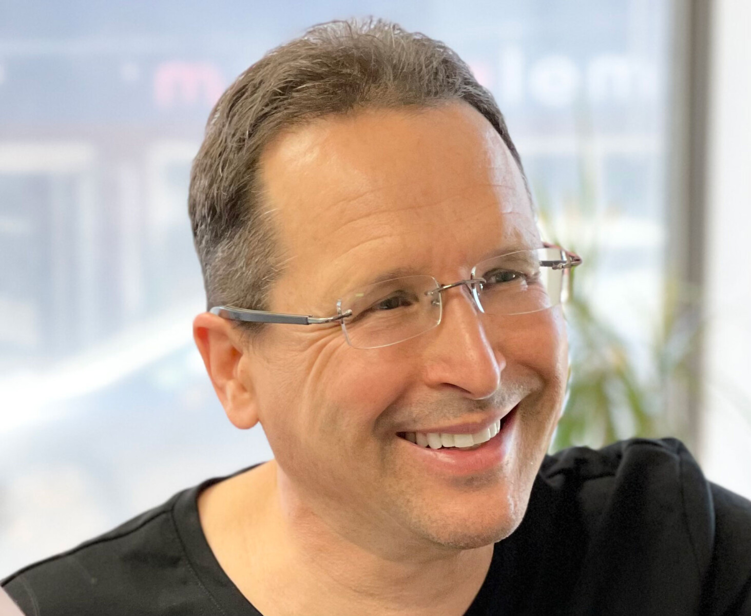 Dr. Dirk Thompson, Calgary dentist, smiling in his Kensington practice